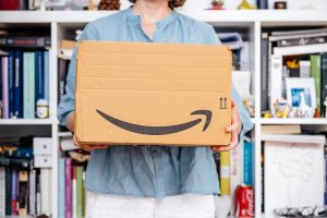 woman holding Amazon cardboard box